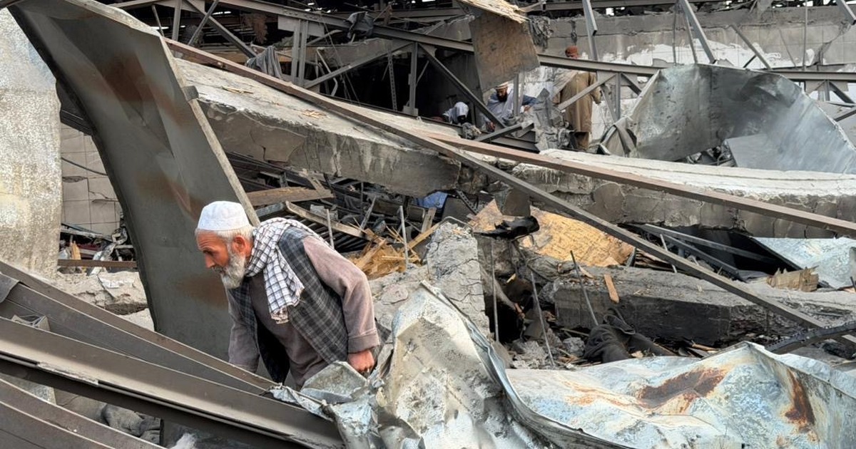 A man walks through the wreckage of a destroyed building after Pakistani airstrikes in Afghanistan.