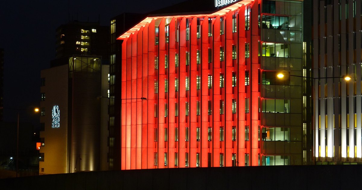 TalkTalk office building in west London lit red at night.