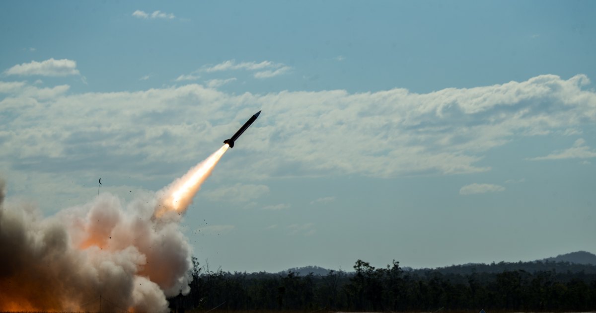 A MIM-104 Patriot launcher deployed in the field, raised towards the sky.