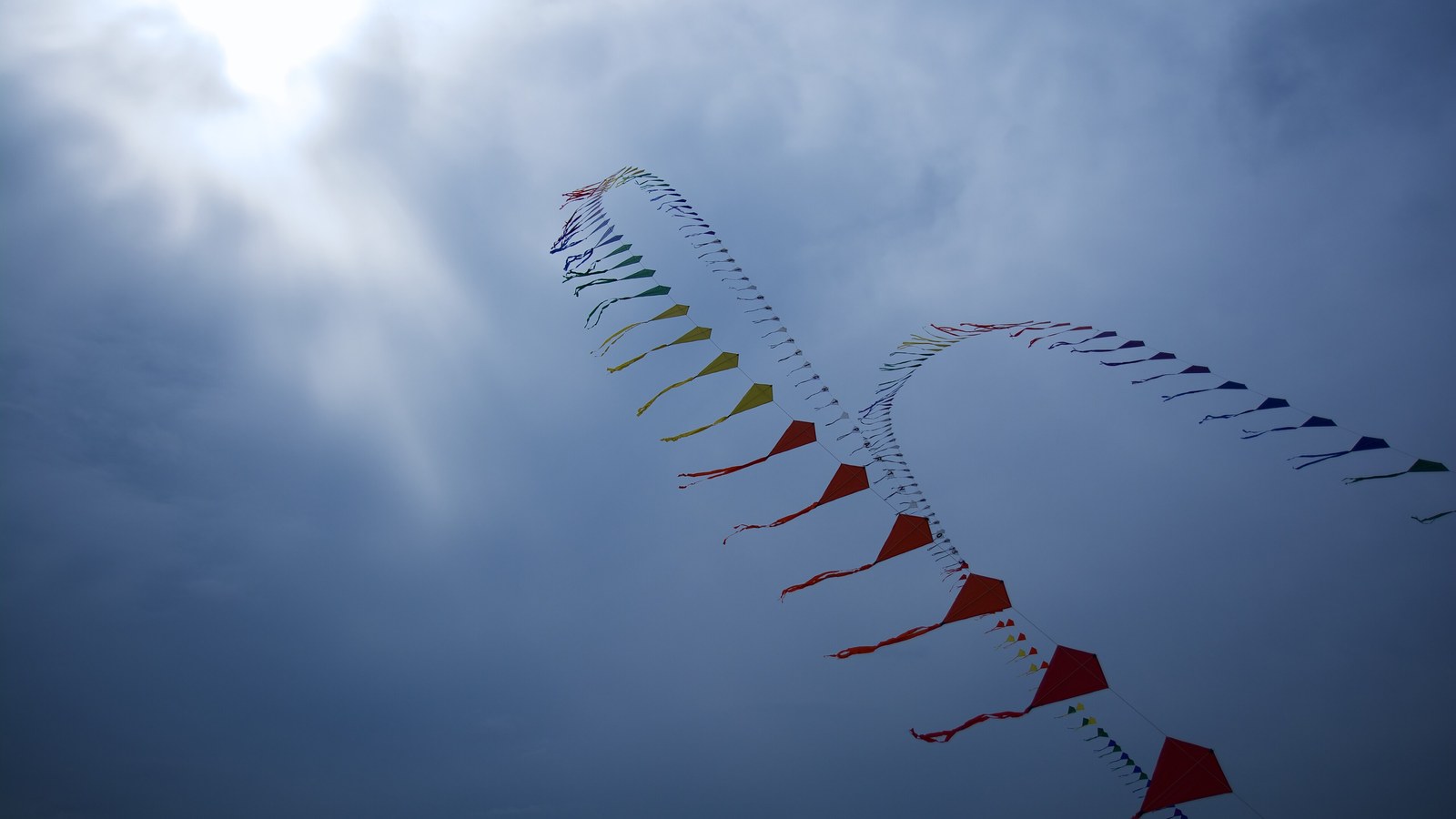 A single kite flying against an open sky, with no people visible.