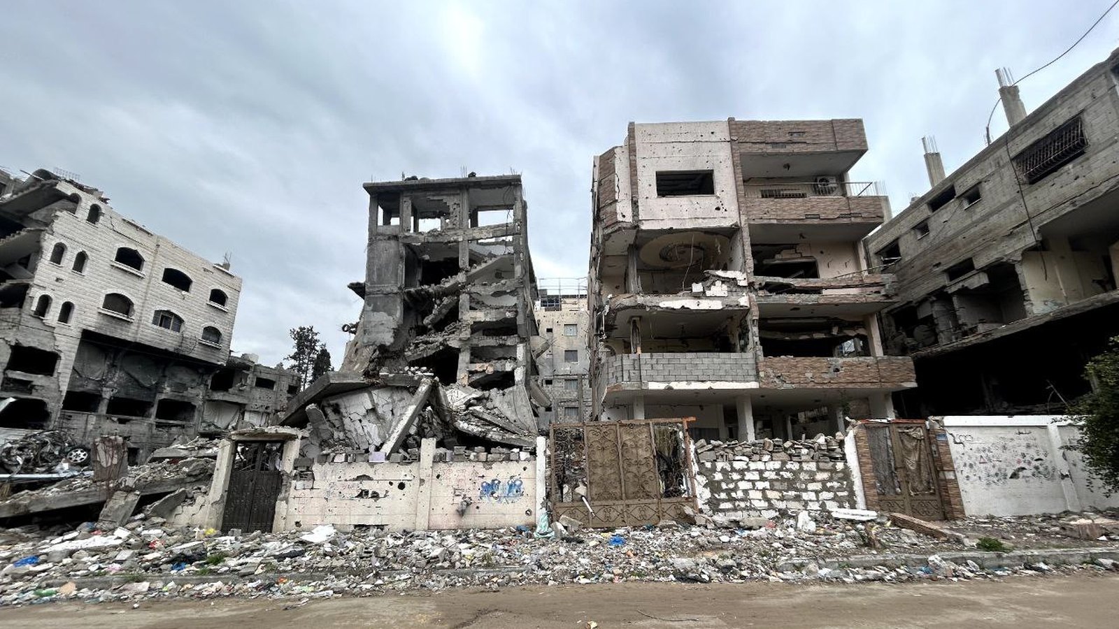 People moving through a damaged urban area in Gaza.