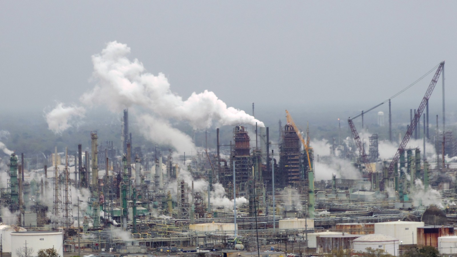 Industrial oil refinery and fuel infrastructure under an open sky.
