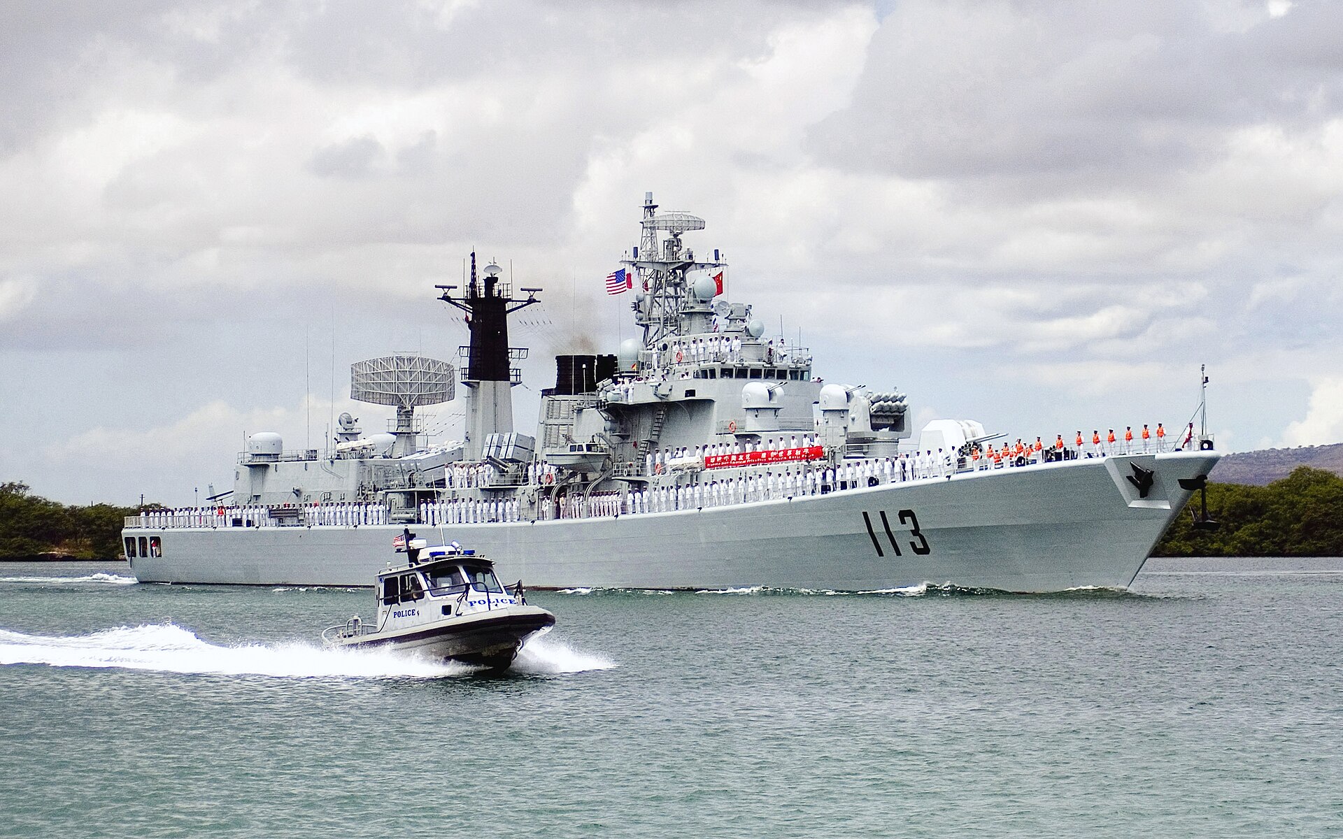 A Chinese Navy guided-missile destroyer sailing through a harbour channel.