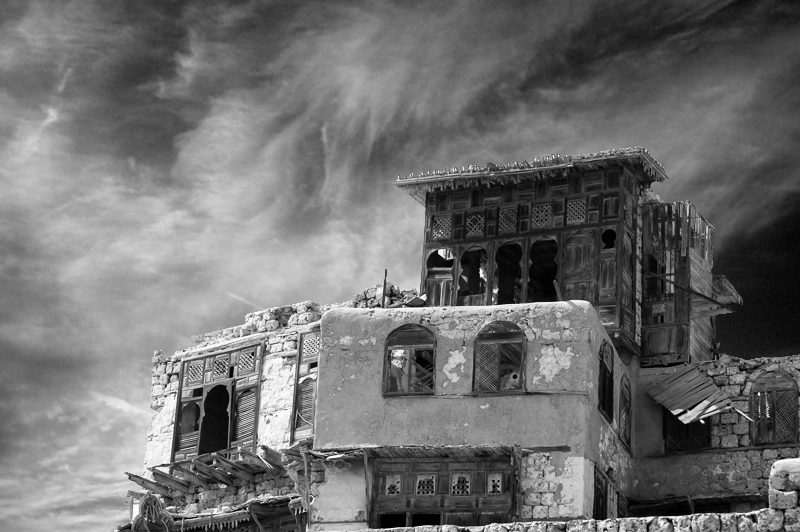 A historic multi-storey building in the Saudi Red Sea city of Yanbu beneath a dramatic sky.