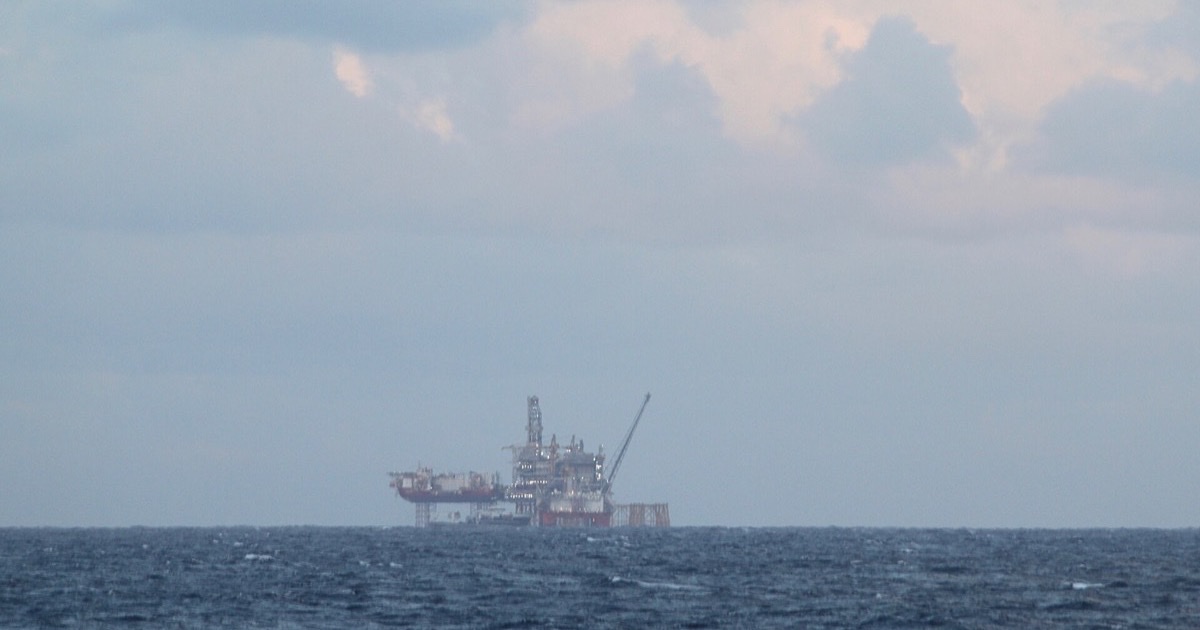 Offshore oil platform standing in the North Sea under a cloudy sky.