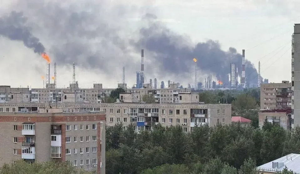An FP-1 drone strike hits the Omsk oil refinery in Russia, with smoke rising from the facility.