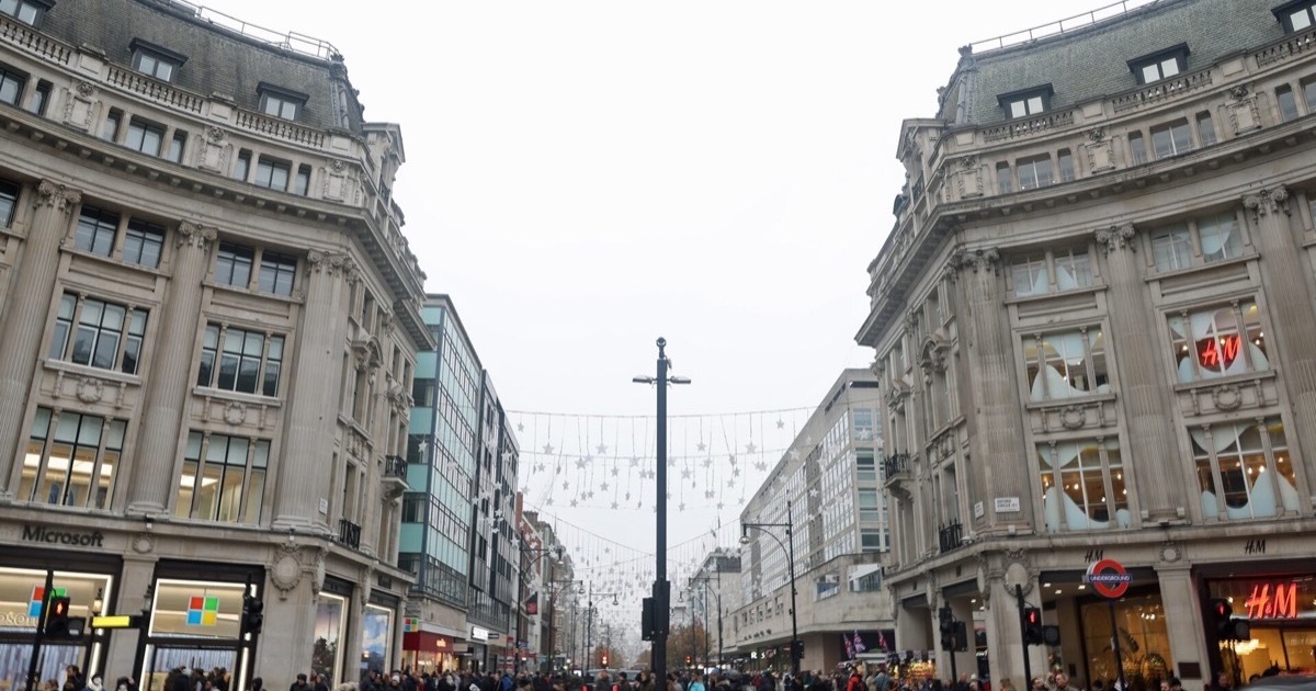 Busy Oxford Street in London with shops, pedestrians and traffic.
