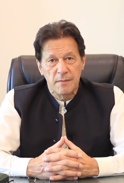 Imran Khan speaking at a podium during the Austrian World Summit.