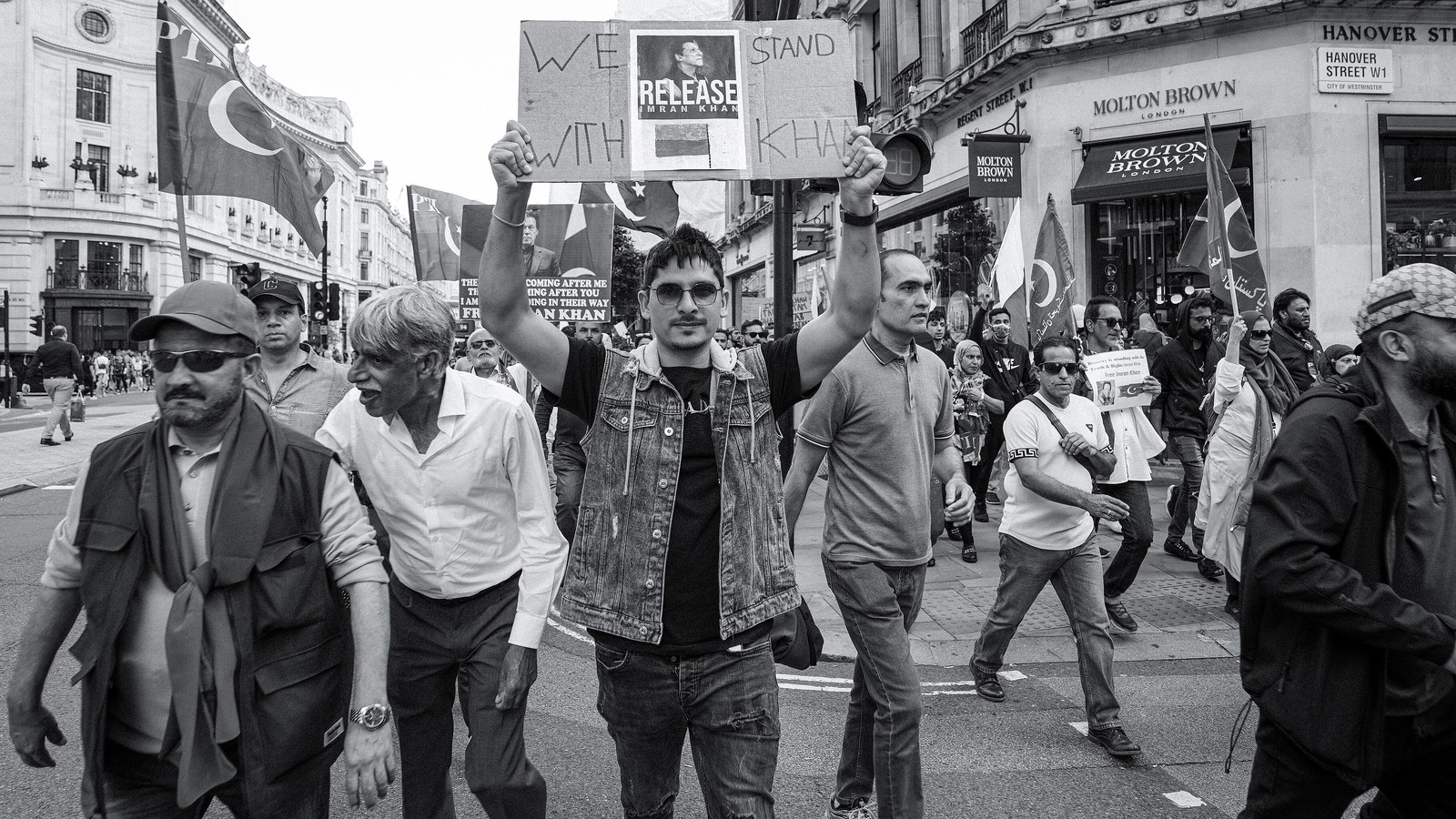 Demonstrators march through central London holding placards and PTI flags calling for Imran Khan’s release.