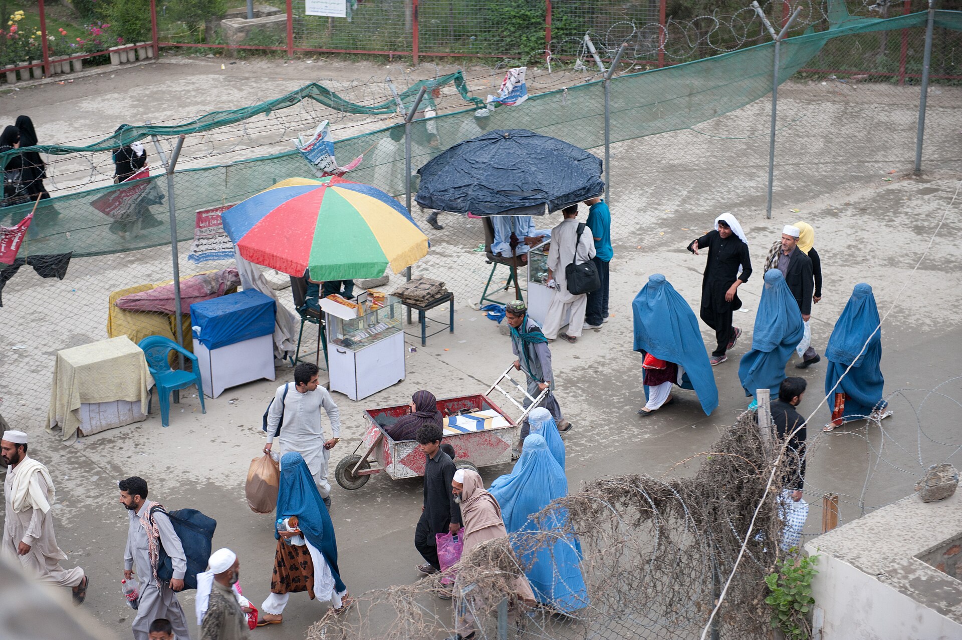 ravellers and vehicles approach the customs and border patrol checkpoint at Torkham Gate on the Afghanistan–Pakistan frontier.