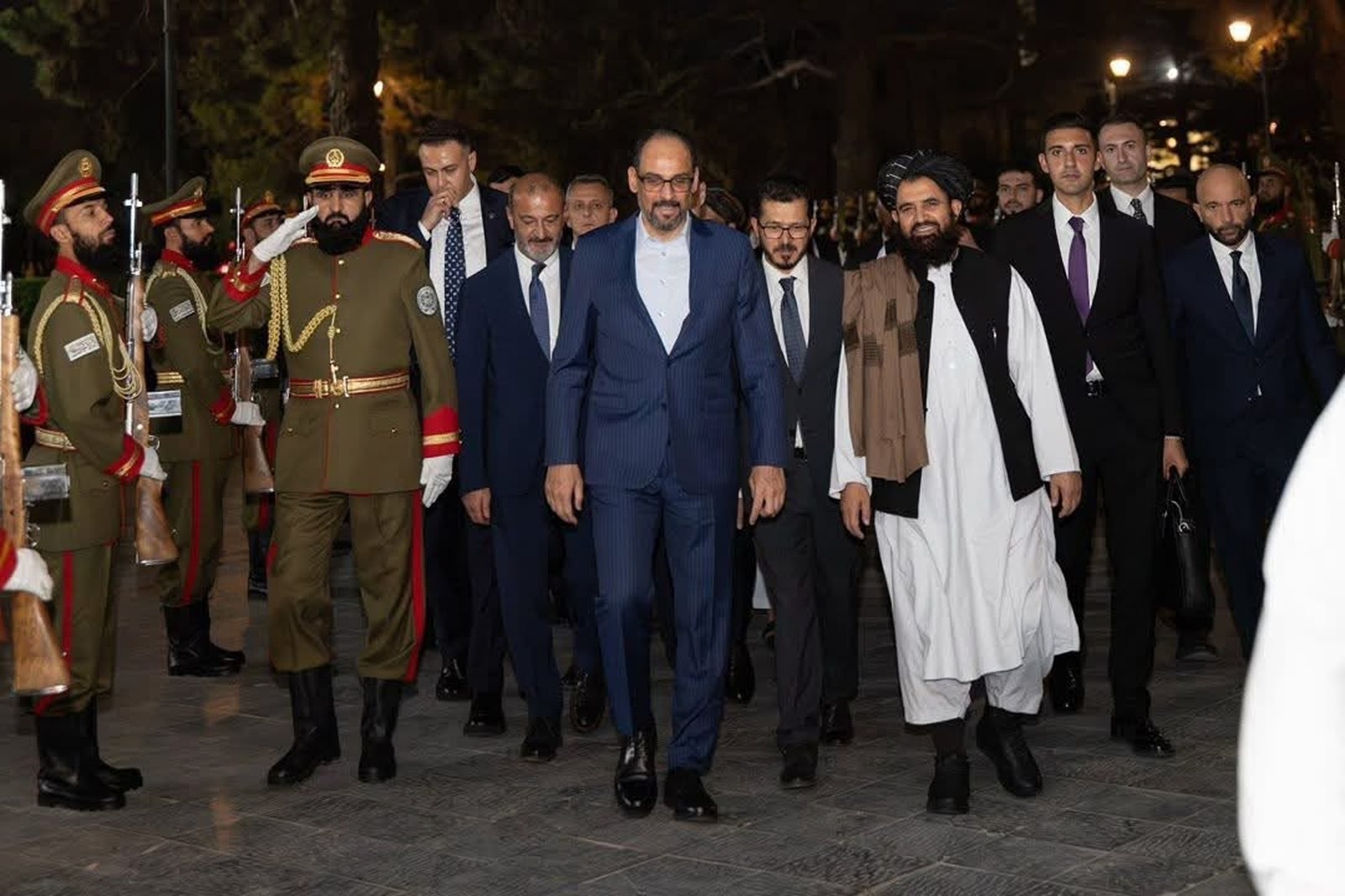 Ibrahim Kalın walking with officials beside an honour guard after meetings in Kabul.