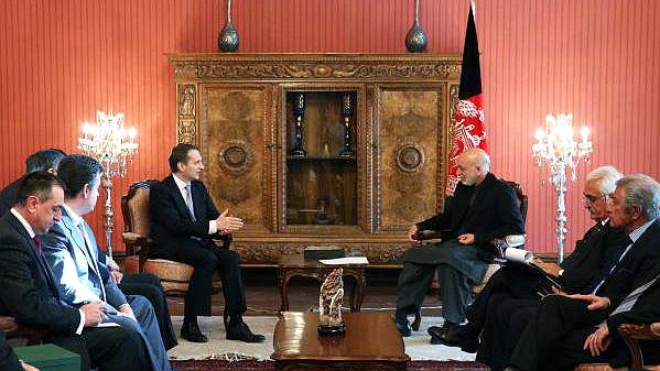Russian official Sergey Naryshkin meets Afghan officials in Kabul with the Afghan flag behind them